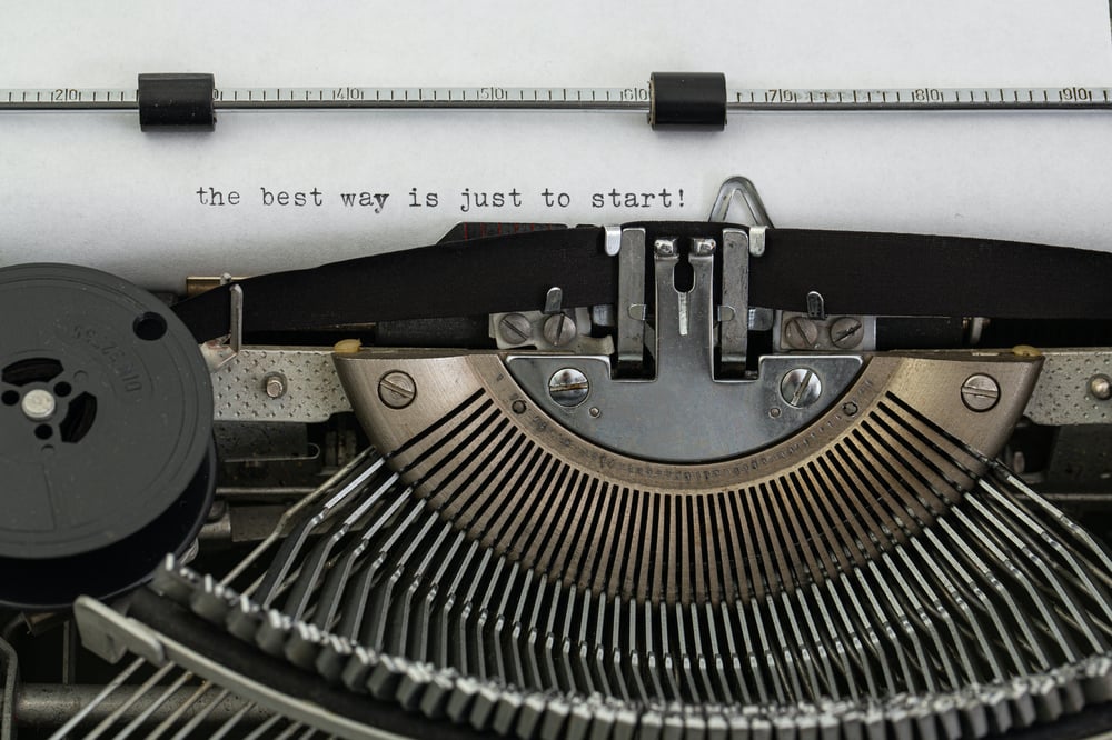 Close up of a sheet of paper in a typewriter with the typed phrase, "the best way is just to start!"