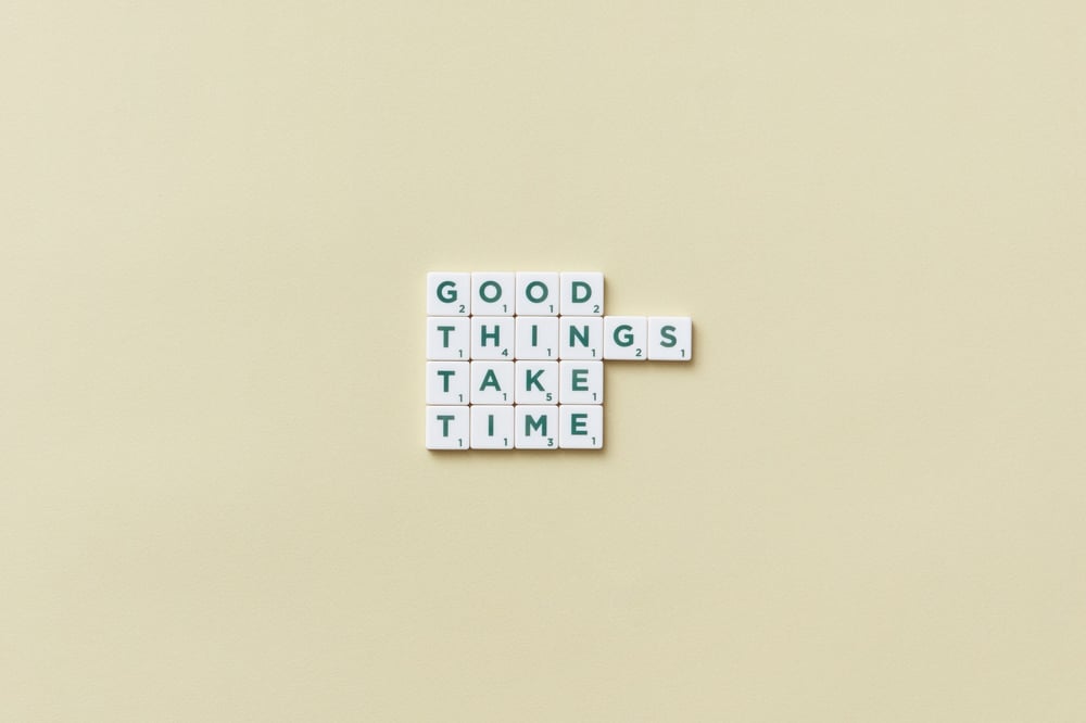 A theme spelled out in scrabble tiles: "Good things take time."