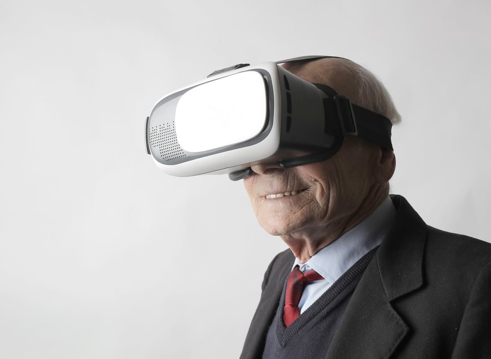 '''Show, don''t tell'' is all about immersing your reader in the world of your story.' A smiling elderly person wears a virtual reality headset.