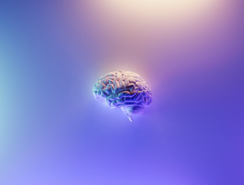 A floating, illuminated brain on a purple background.