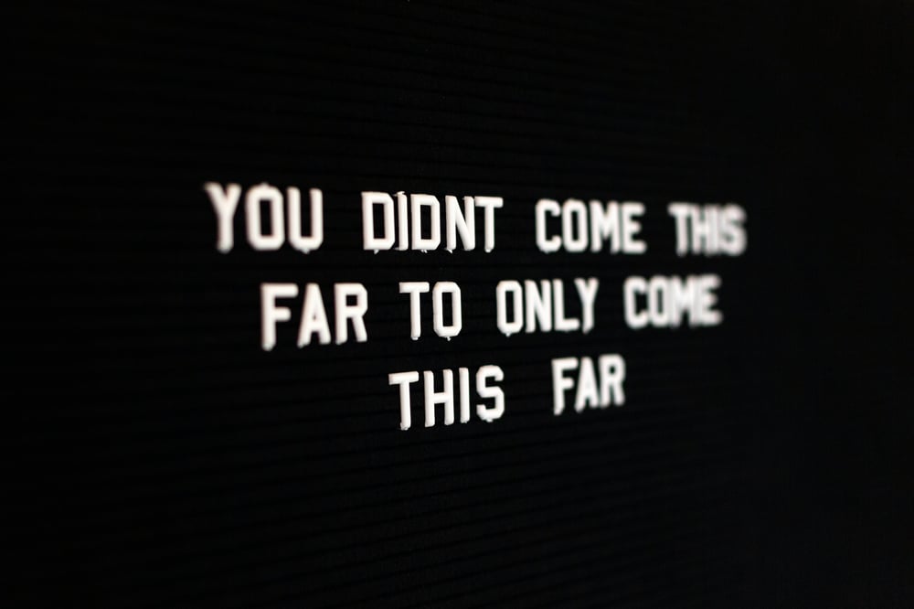 A black letter board with the inspirational quote "You didn't come this far to only come this far."