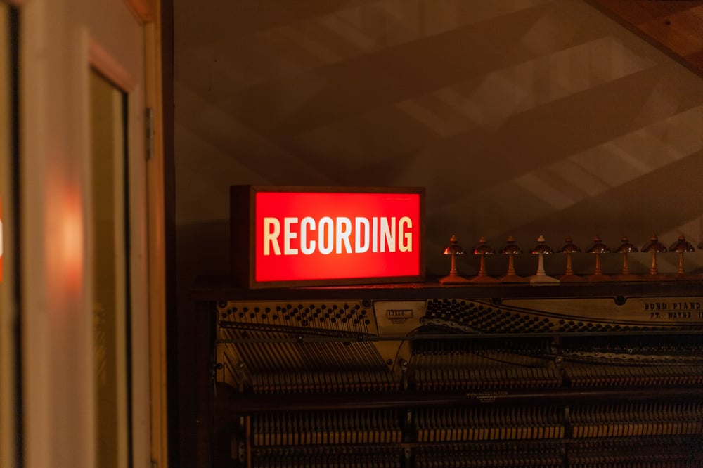 A red light-up sign that reads, "RECORDING".