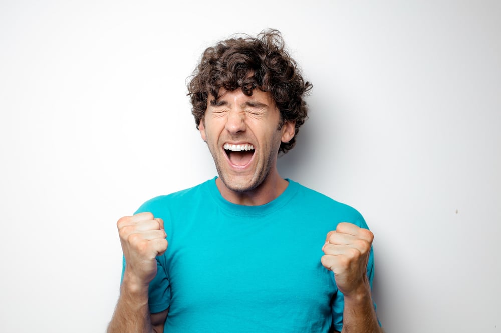 A male-presenting person shouts in excitement.