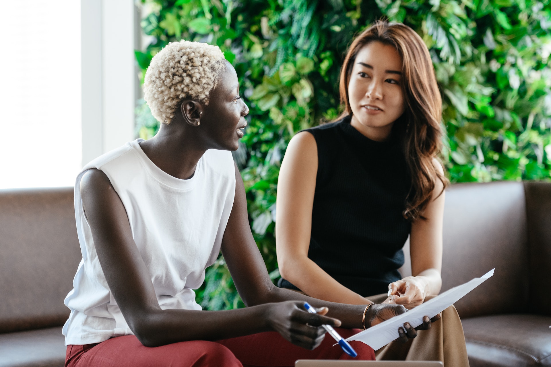 Two people have a conversation over a contract.