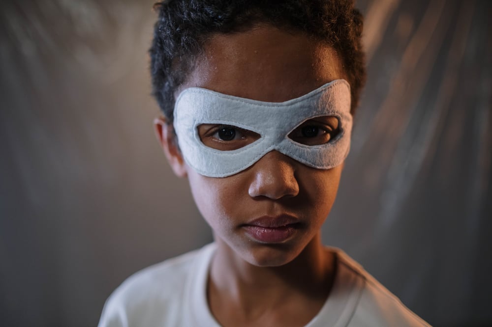 A kid in a superhero mask.