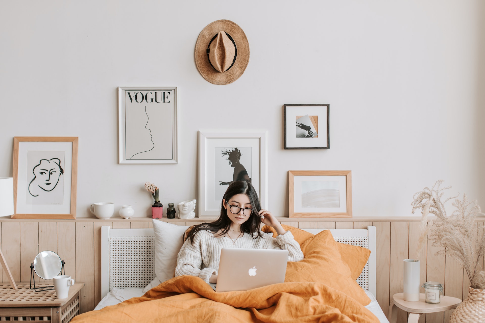 A person works on the computer in bed.