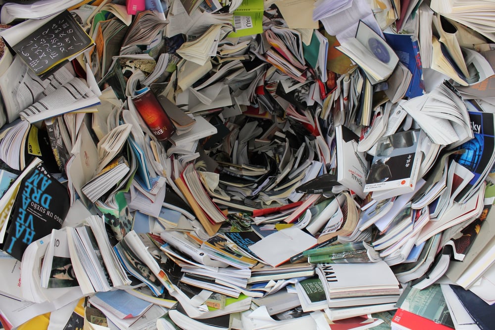 A messy tunnel made of paperback books.