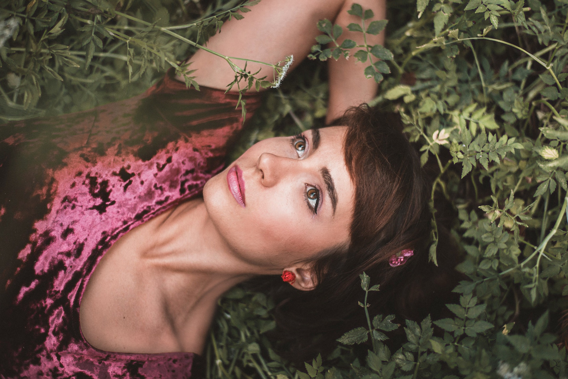 A princess lies on the ground, staring into the distance.