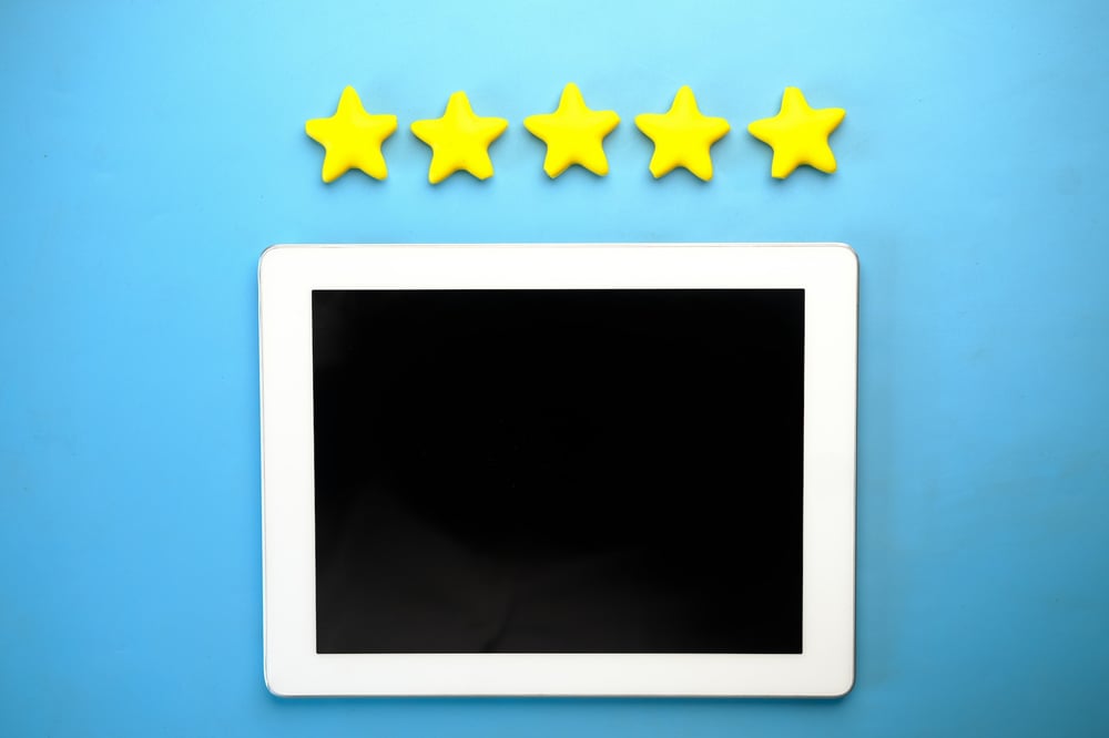 Five gold stars above a blank computer tablet.