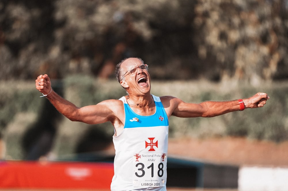 An older runner finishes a race.