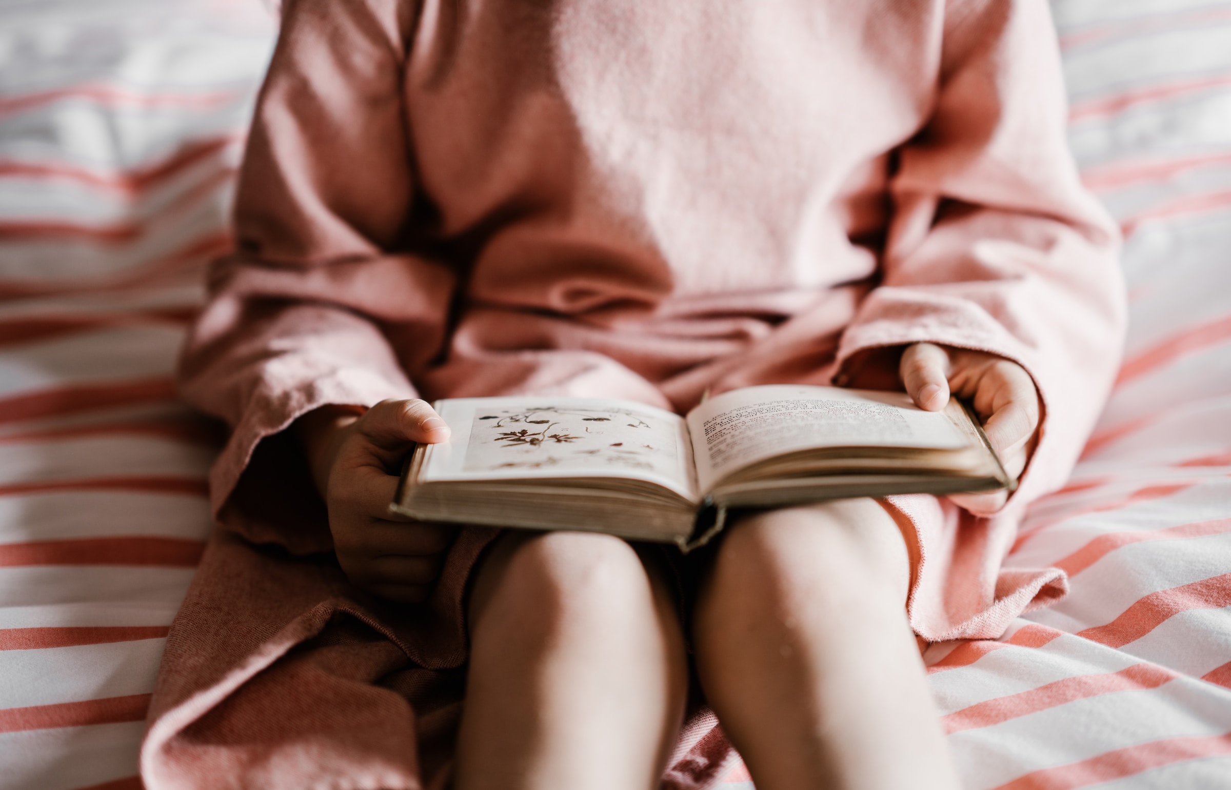 An open book on a child's lap.