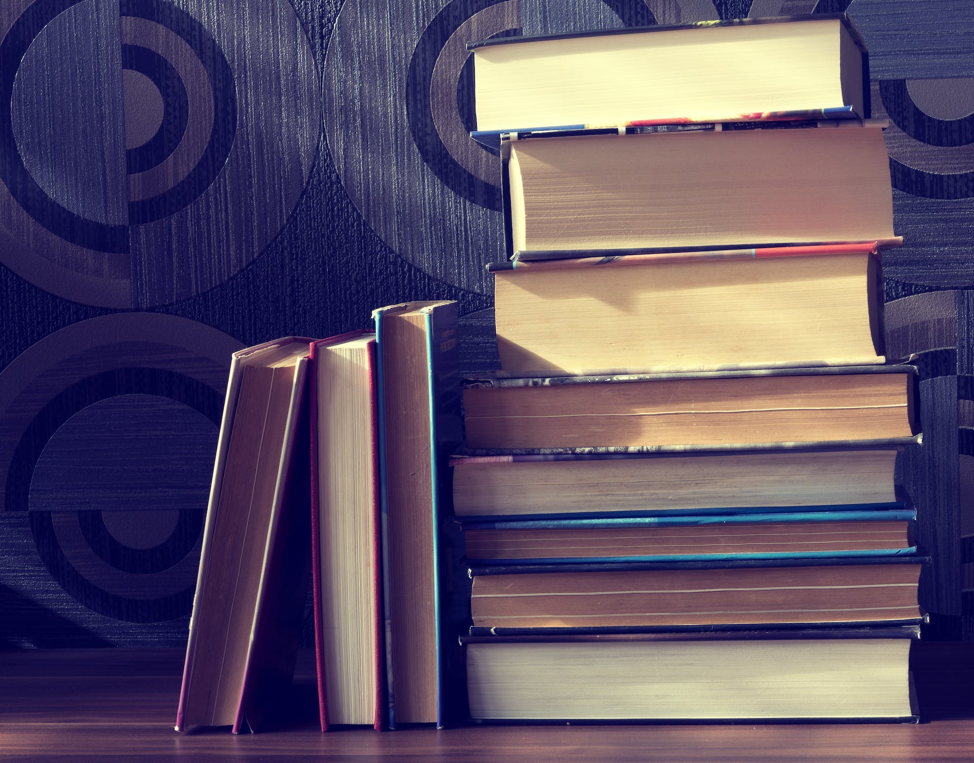 A stack of books with their spines facing away.