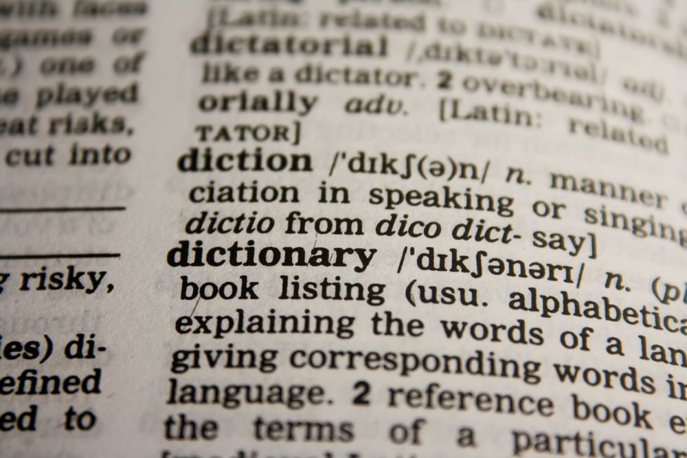 An open dictionary showing the entry for the words "diction" and "dictionary."