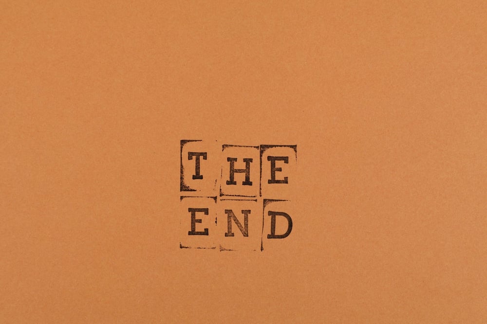 The letters "THE END" stamped on a goldenrod background.