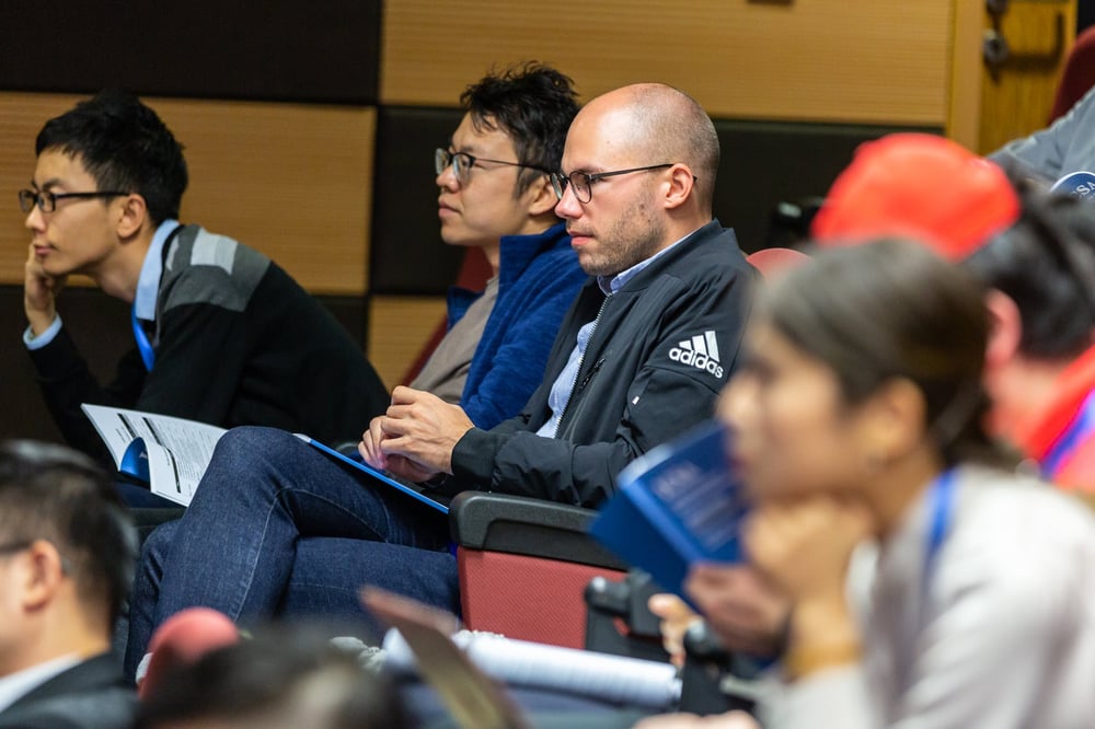 College students sit in an auditorium.