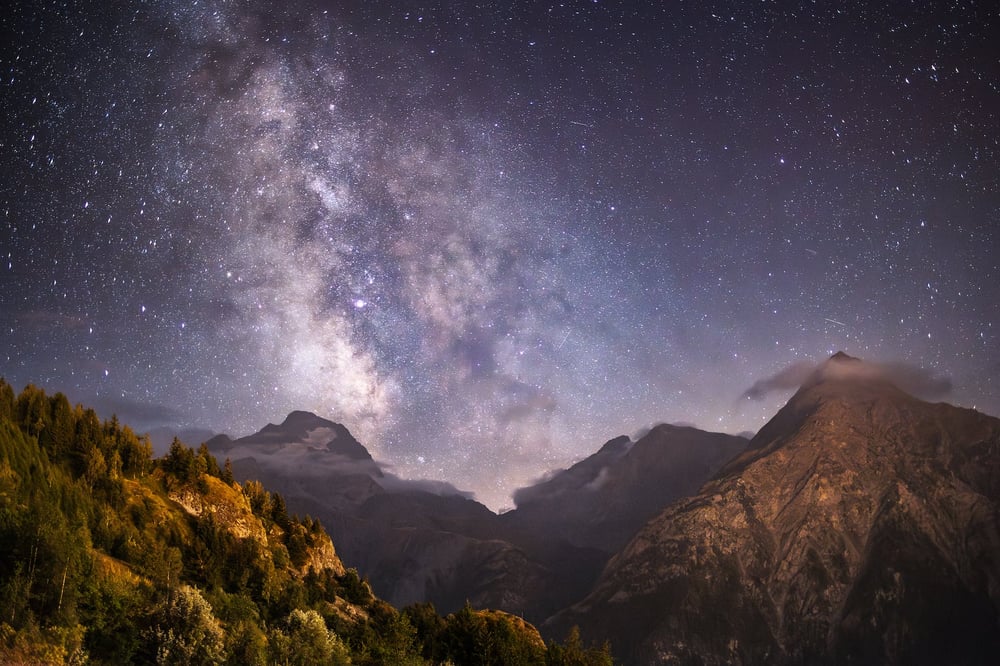 The Milky Way visible in the night sky over the mountains.