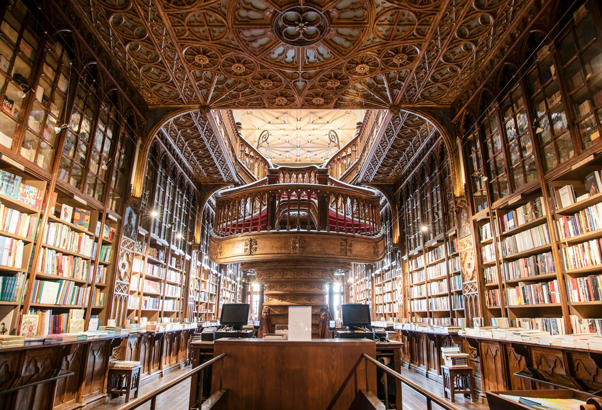 A beautiful library with ornate ceilings and a grand staircase.