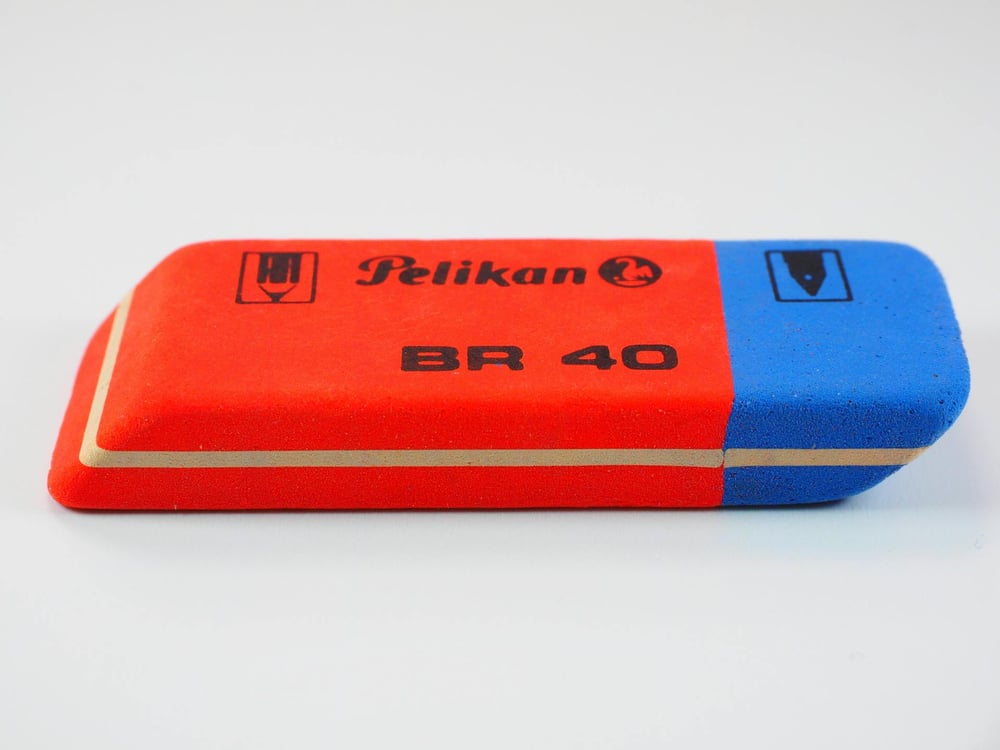 A red, blue, and yellow stick eraser.
