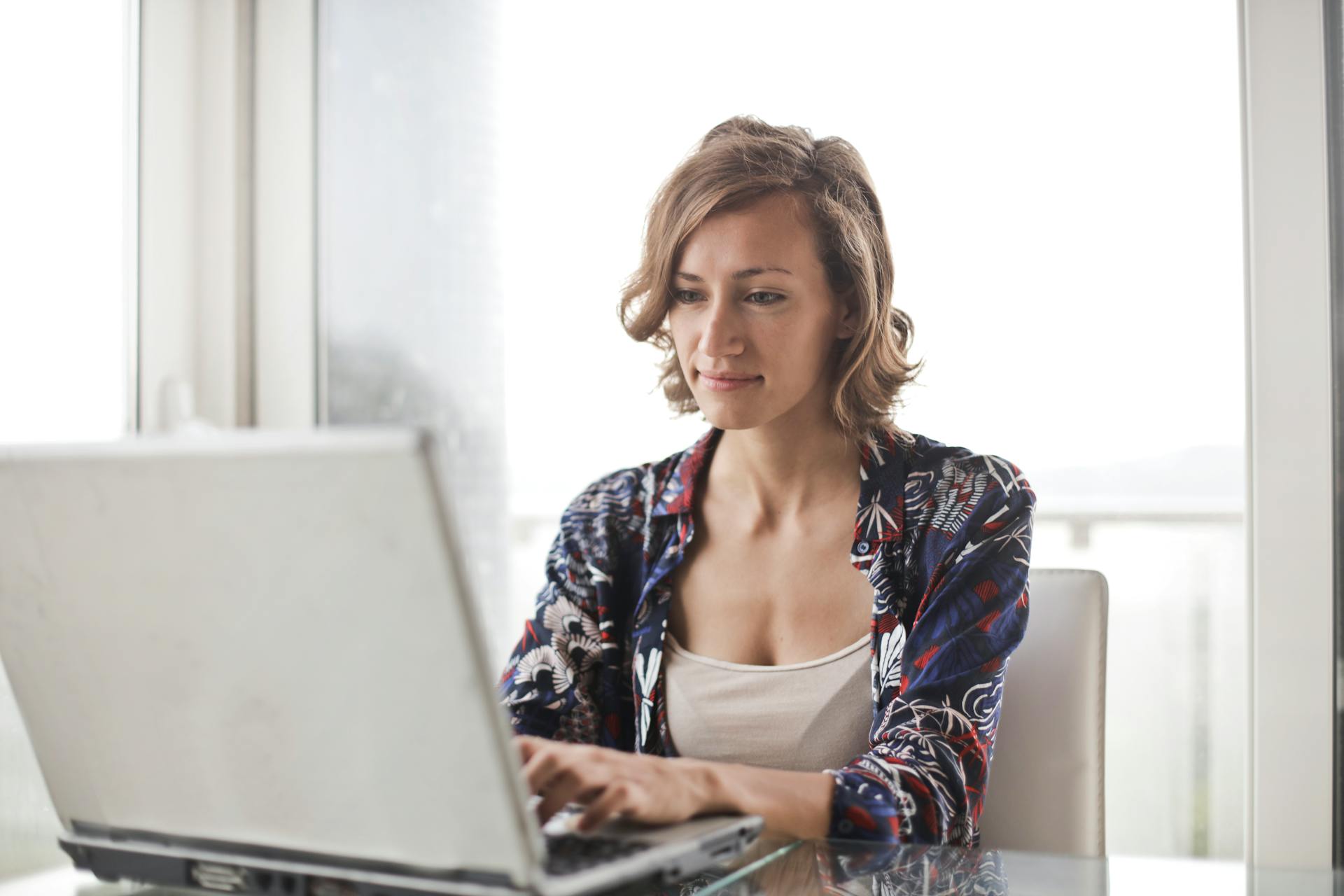 A person types on a laptop.