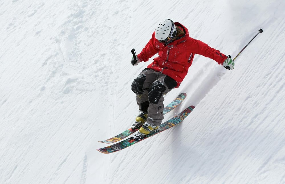 A person skis fast down a steep hill.