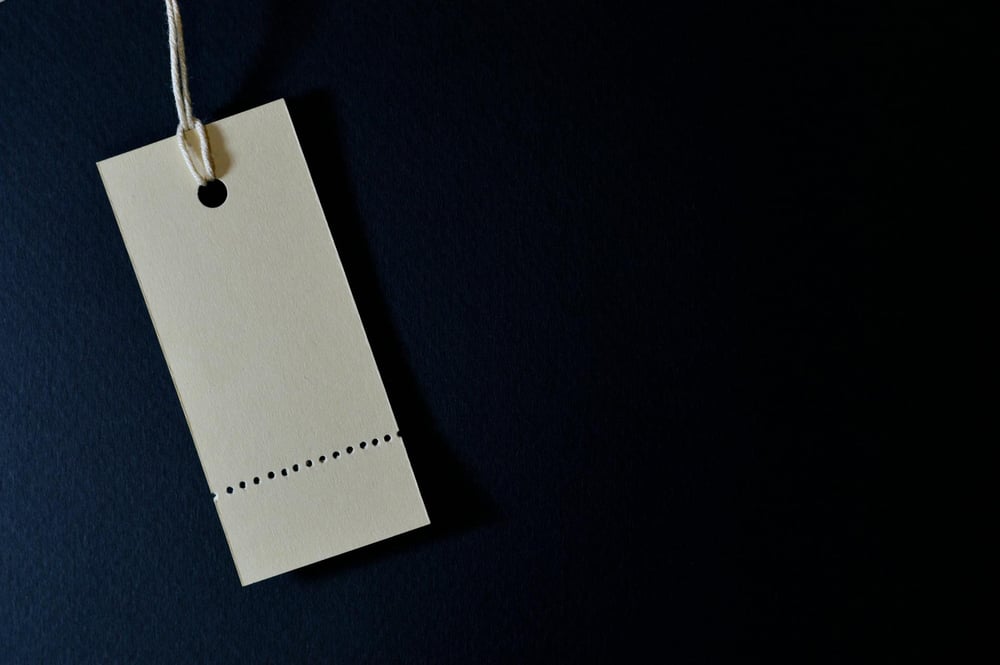 A blank price tag on a black background.