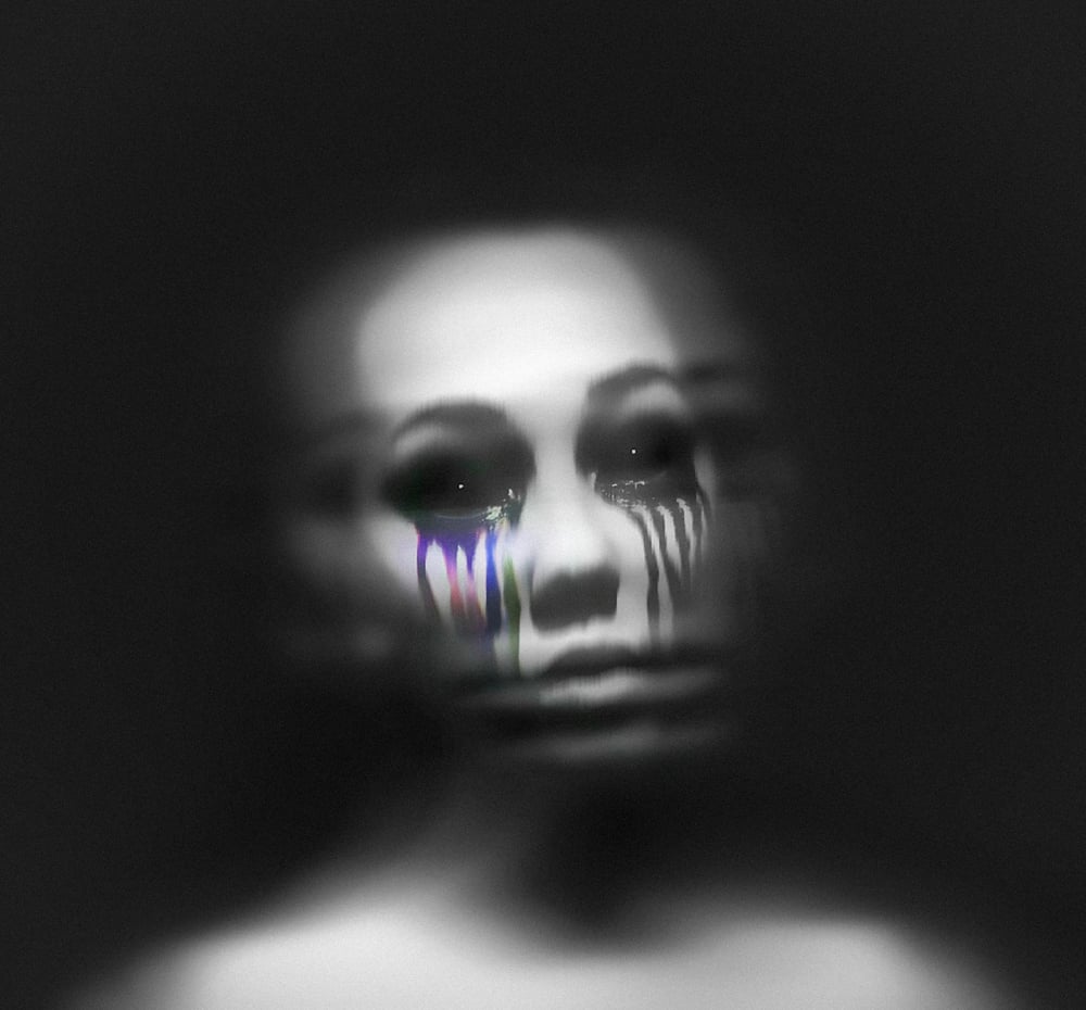 A blurry, human-like being with black and blue ink pouring out of their eyes.