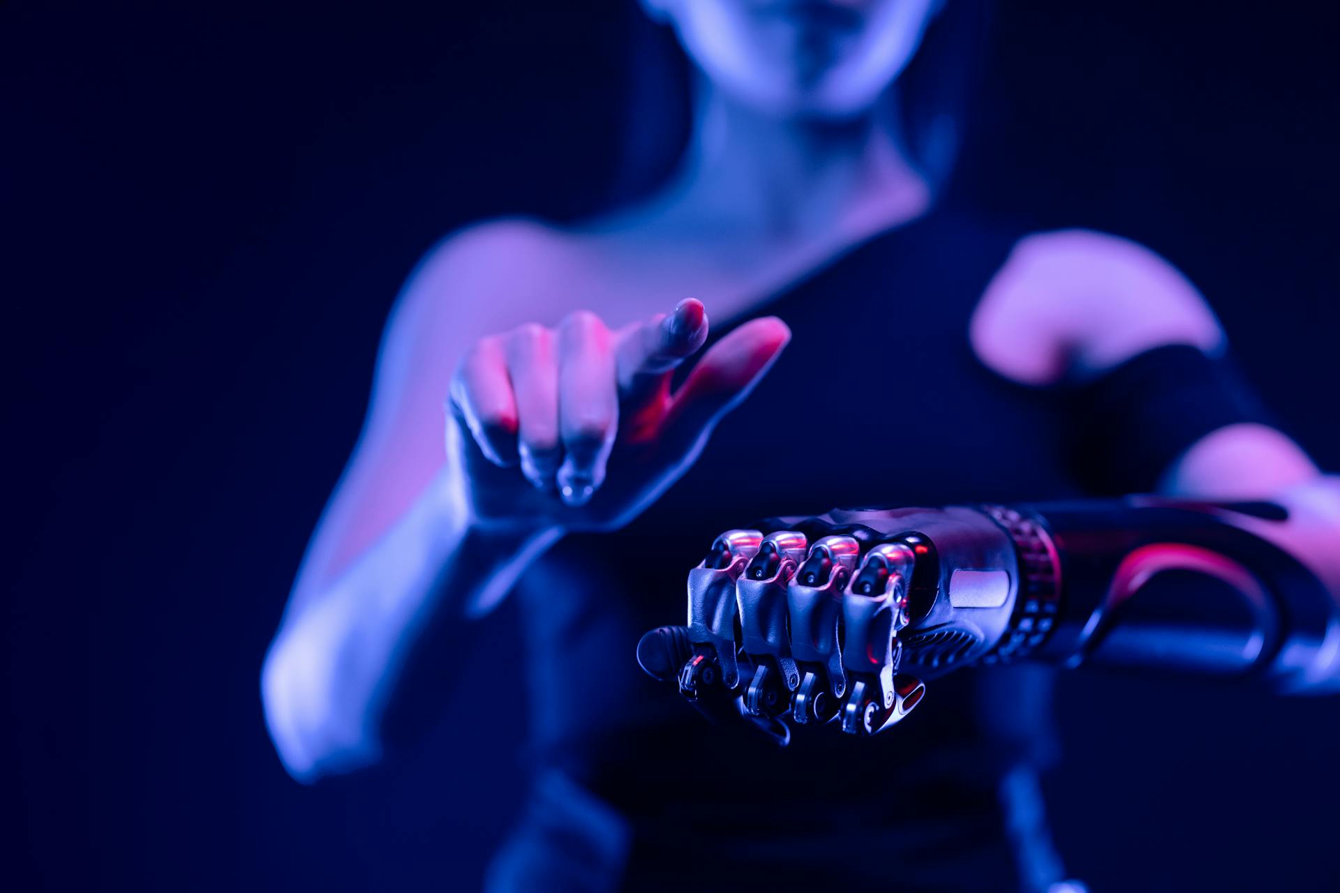 A person holds out a cybernetic arm.