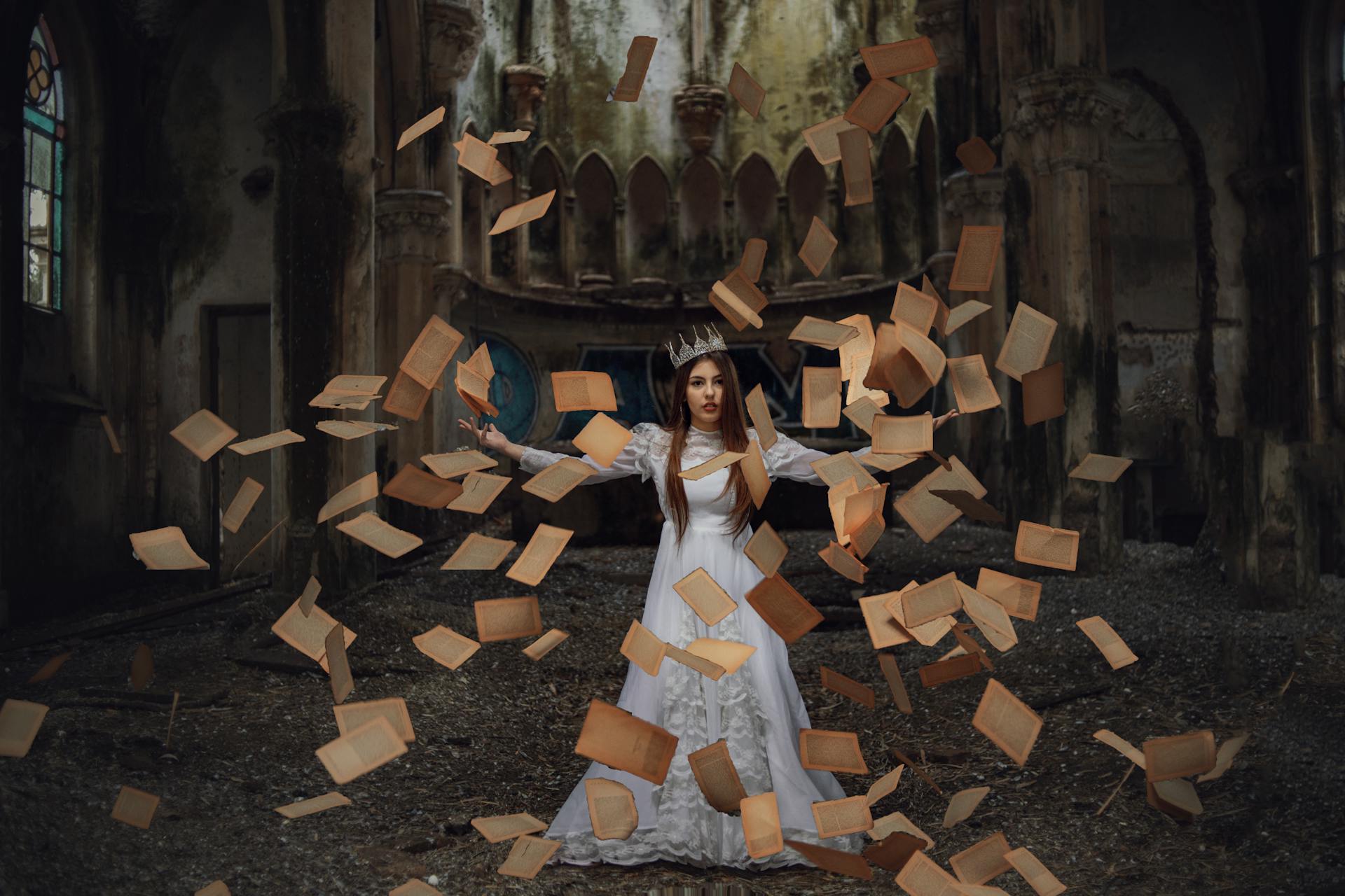 A queen stands in a cathedral with pages flying through the air around her.