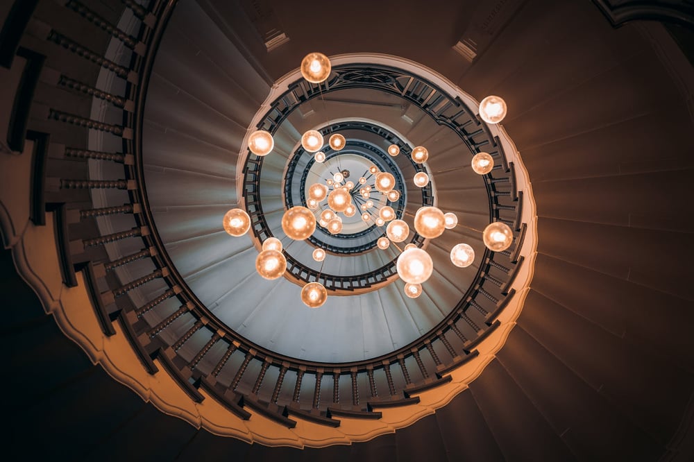A view of a long, winding staircase from below.