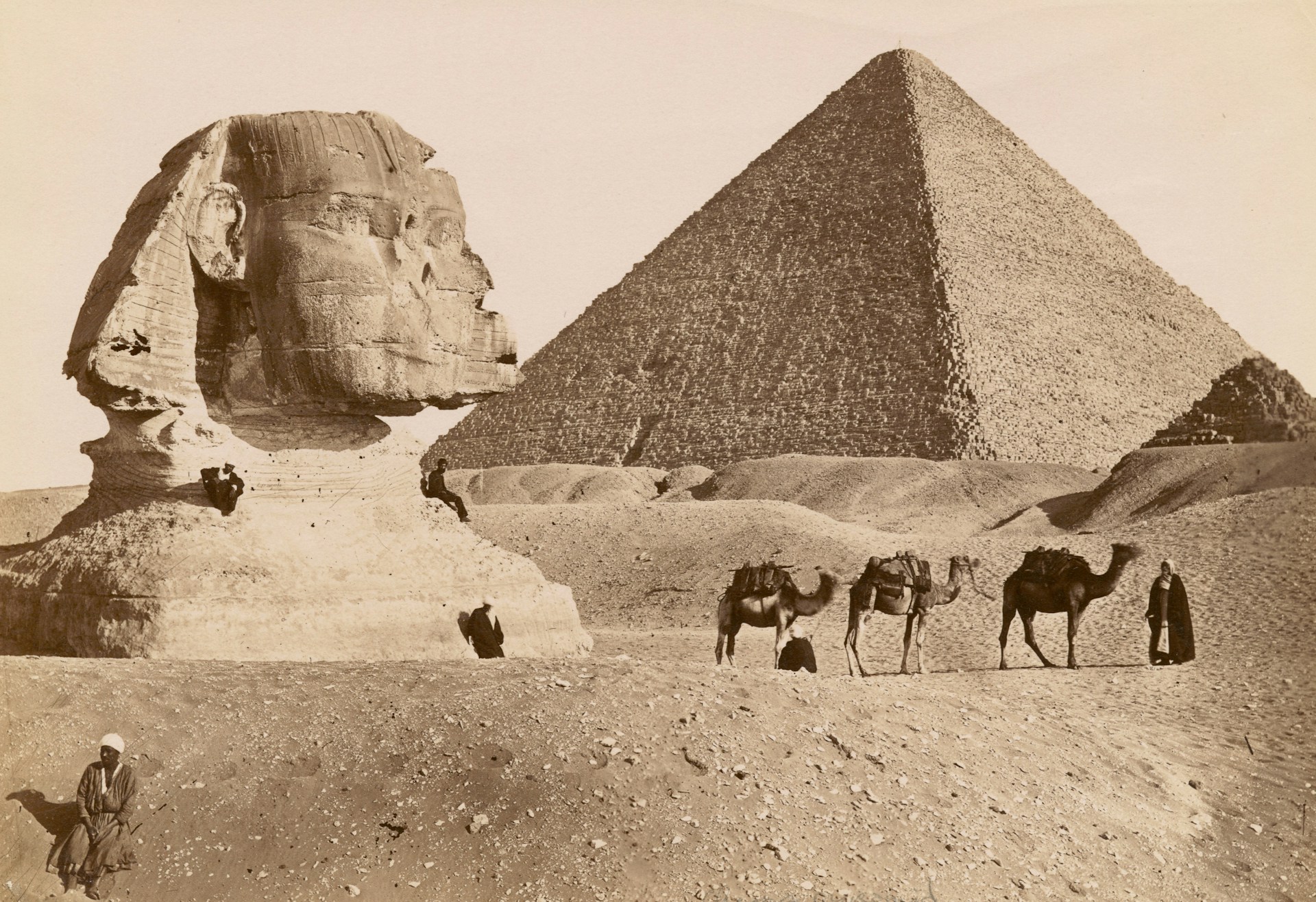 An old sepia-tone photograph of the Sphinx and Pyramids.
