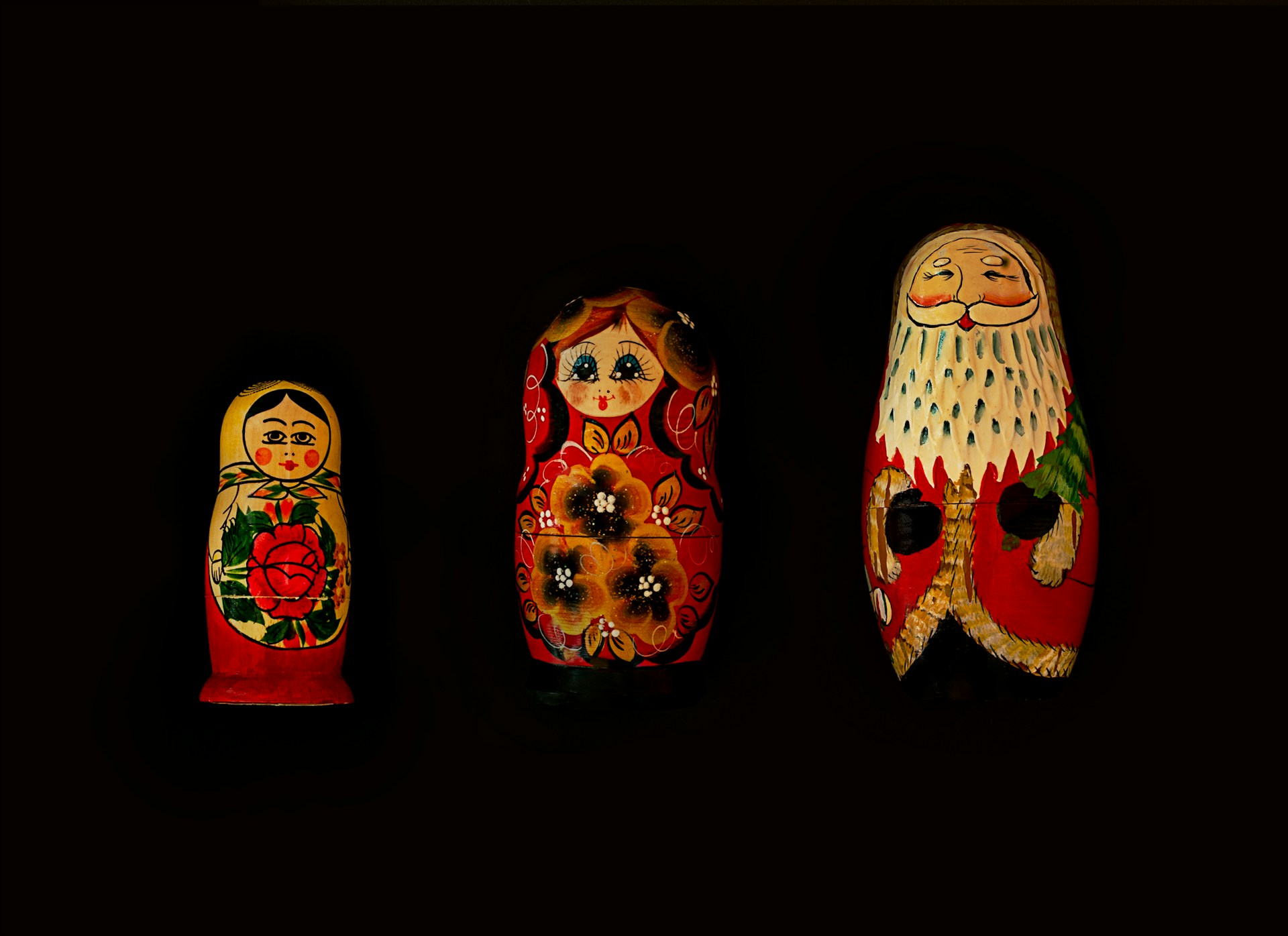 Three Russian nesting dolls in a row from smallest to largest.