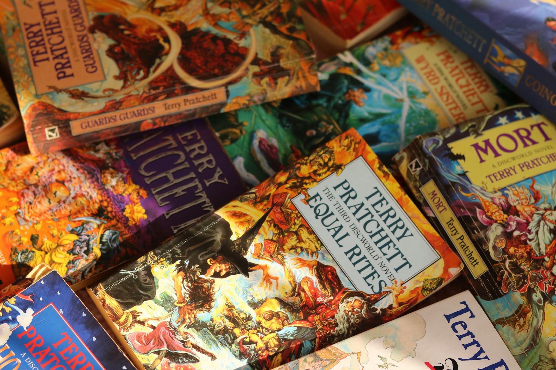 A pile of Terry Pratchett Discworld novels.