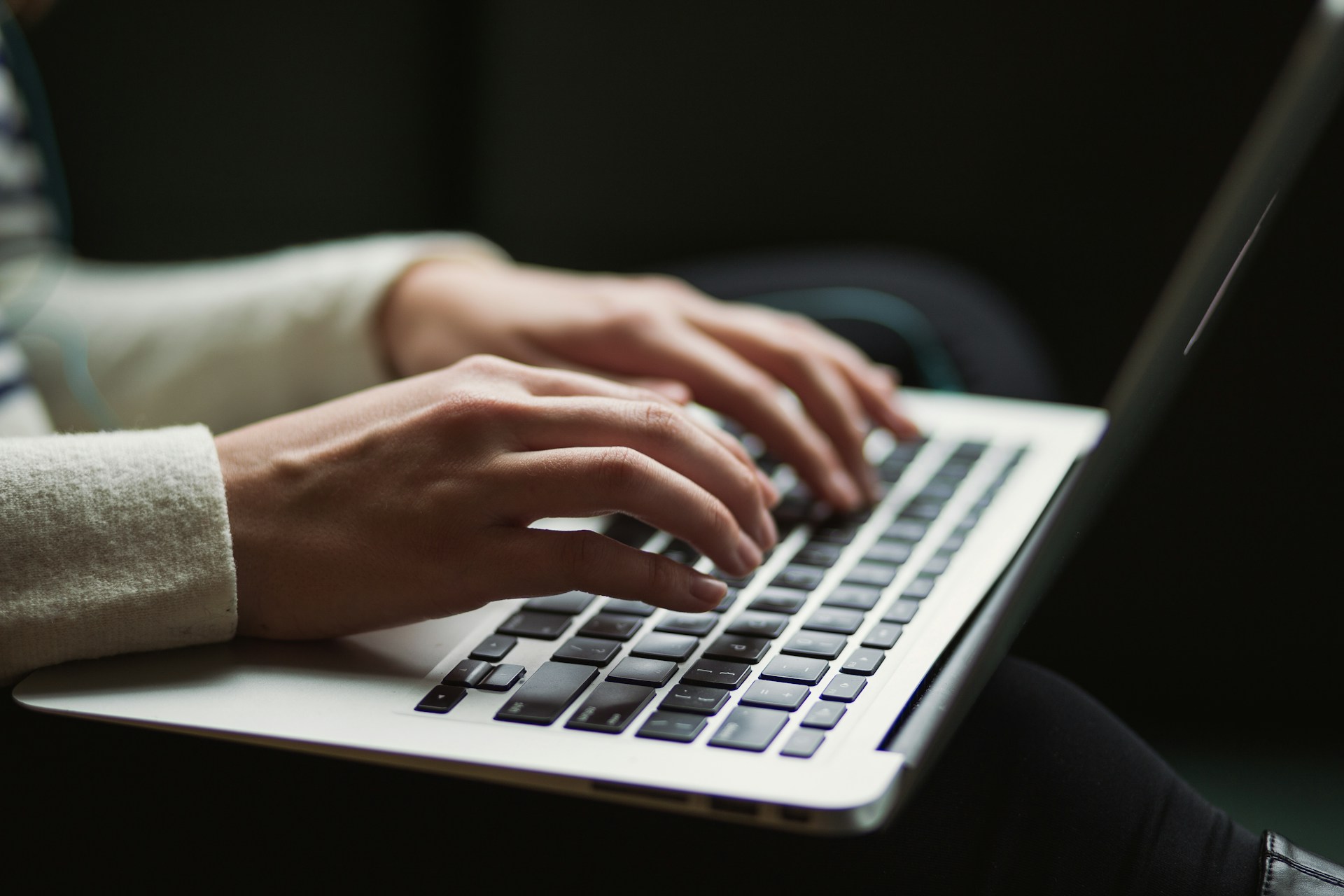 Two hands on a computer keyboard.
