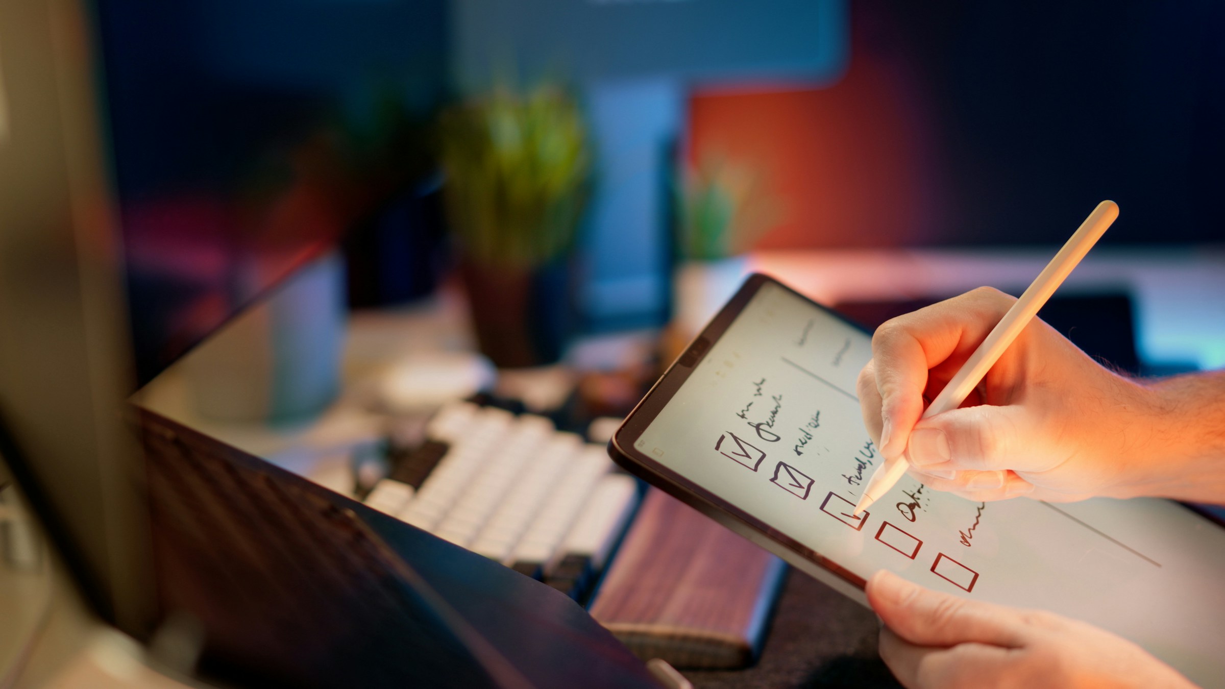A hand checks off boxes on a tablet.