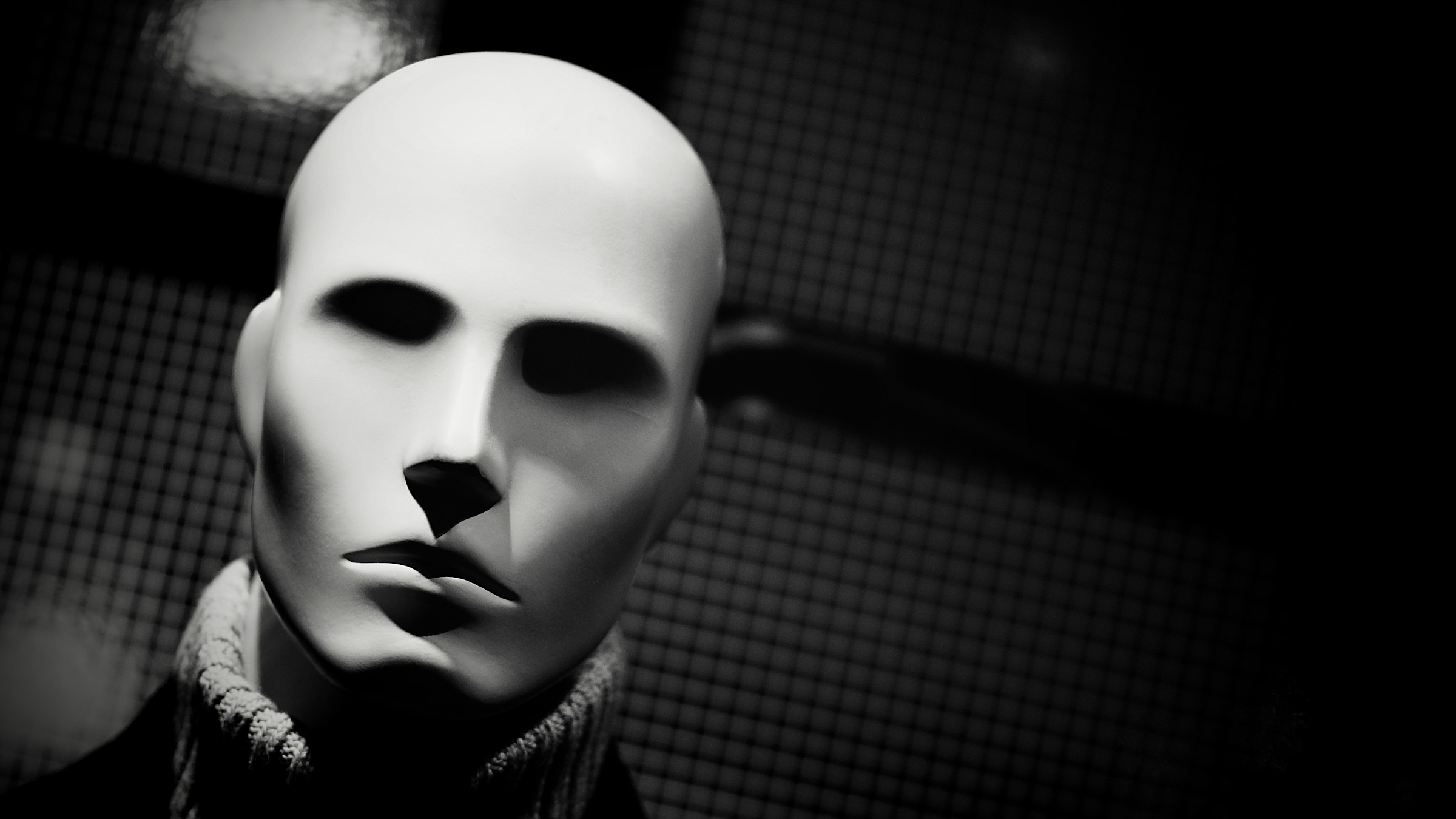 A shadowy-eyed mannequin in a turtleneck.